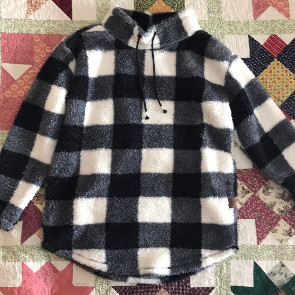 Medium ladies warm fuzzy sweater worn once. Pockets but no hood. Black & white